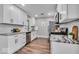 Modern kitchen with stainless steel appliances, marble countertops, and white cabinetry; ample storage at 5850 E 54Th Pl, Indianapolis, IN 46226