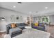 Spacious living room featuring comfortable sofas, stylish decor, and an open floor plan into the dining area at 5850 E 54Th Pl, Indianapolis, IN 46226