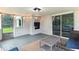 Relaxing sunroom featuring a brick fireplace and sliding glass doors to enjoy the outdoors at 5850 E 54Th Pl, Indianapolis, IN 46226
