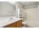 Bright bathroom with vanity, mirror, tub-shower combo, and extra storage at 5935 Oakforge Ln, Indianapolis, IN 46254