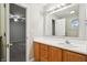 Modern bathroom featuring a wood vanity, white sink, and neutral walls at 5935 Oakforge Ln, Indianapolis, IN 46254