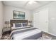Calm bedroom featuring a queen-sized bed, soft rug, and sliding door closet at 5935 Oakforge Ln, Indianapolis, IN 46254