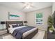 Inviting bedroom with a queen-sized bed, stylish decor, and ample natural light from the window at 5935 Oakforge Ln, Indianapolis, IN 46254