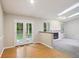 Open dining area with hardwood floors and adjacent to a living room with a fireplace at 5935 Oakforge Ln, Indianapolis, IN 46254