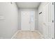 Entryway with tile flooring, a white front door with sidelights, and a coat rack at 5935 Oakforge Ln, Indianapolis, IN 46254
