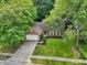 Aerial view of a charming brick home with a well-manicured lawn and beautiful mature shade trees at 5935 Oakforge Ln, Indianapolis, IN 46254