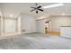 Spacious living room featuring vaulted ceilings, gray carpet, and an open view of the kitchen at 5935 Oakforge Ln, Indianapolis, IN 46254