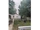 Backyard oasis with fire pit, Adirondack chairs, and vintage string lighting for entertaining at 597 W Adams St, Franklin, IN 46131