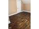 Spacious bedroom with dark hardwood floors, white trim, neutral wall color, and a standard closet at 597 W Adams St, Franklin, IN 46131