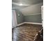 Large bedroom with wood flooring and neutral decor is ready for furnishings and personalization at 597 W Adams St, Franklin, IN 46131