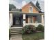 Charming home's front porch with swing, flowers, and well maintained landscape at 597 W Adams St, Franklin, IN 46131