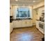 Bright kitchen featuring white cabinets, modern appliances, and wooden floors at 597 W Adams St, Franklin, IN 46131