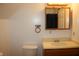 Bathroom with a wood vanity, a large framed mirror, and a white toilet at 6052 N Deckshire Ln, Shirley, IN 47384