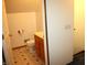 This bathroom boasts patterned floors, a cream-colored countertop, and an open doorway at 6052 N Deckshire Ln, Shirley, IN 47384