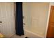 Bathroom features a pristine shower/tub combo and a navy shower curtain, complemented by light tile floors at 6052 N Deckshire Ln, Shirley, IN 47384