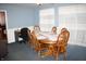 Dining room with blue walls, wood table with seating for six, and bright natural light at 6052 N Deckshire Ln, Shirley, IN 47384