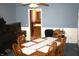 Dining room with blue walls, wood table with seating for six, and wood piano at 6052 N Deckshire Ln, Shirley, IN 47384