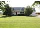 Charming two-story home with a well-manicured lawn, a red front door and inviting curb appeal at 6052 N Deckshire Ln, Shirley, IN 47384
