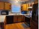 Updated kitchen with stainless steel appliances, wood cabinets, and modern flooring at 6052 N Deckshire Ln, Shirley, IN 47384