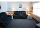 Cozy living room features comfortable blue sofas, lamps, and charming nautical decor at 6052 N Deckshire Ln, Shirley, IN 47384