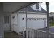 View from the side porch showing the garage, an exterior door, and white railings at 6052 N Deckshire Ln, Shirley, IN 47384