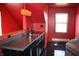 The wet bar features dark cabinets and countertops, and stylish pendant lighting at 6052 N Deckshire Ln, Shirley, IN 47384