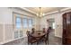 Charming dining room with classic chandelier, built-in bench seating and trim details at 622 N Dequincy St, Indianapolis, IN 46201
