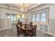 Beautiful dining room with chandelier, natural light, built-in seating and classic trim at 622 N Dequincy St, Indianapolis, IN 46201