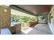Spacious covered front porch featuring classic brickwork, comfortable seating, and a view of the neighborhood at 622 N Dequincy St, Indianapolis, IN 46201