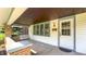 Charming covered front porch with a swing, classic columns, and a welcoming entrance at 622 N Dequincy St, Indianapolis, IN 46201
