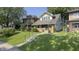 Inviting two-story home with a well-kept lawn, brick accents, and a charming front porch at 622 N Dequincy St, Indianapolis, IN 46201