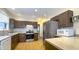 Spacious kitchen with stainless steel refrigerator, dark cabinets, and tile backsplash at 622 N Dequincy St, Indianapolis, IN 46201