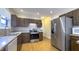 Well-lit kitchen features stainless steel appliances, wood cabinets, and wood flooring at 622 N Dequincy St, Indianapolis, IN 46201