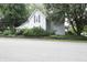 View of home with mature trees and simple landscaping at 633 N East St, Greenfield, IN 46140