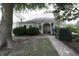Charming single-story home with a cozy front porch and well-maintained landscaping at 633 N East St, Greenfield, IN 46140