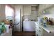 Functional kitchen featuring white cabinetry, essential appliances, and in-unit laundry facilities at 633 N East St, Greenfield, IN 46140