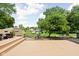 Spacious backyard featuring a stone patio, fire pit, mature trees, and ample seating areas for outdoor enjoyment at 6429 Walnut Way, Brownsburg, IN 46112