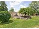 Landscaped backyard featuring a patio, deck, a barbecue area, and a stone-lined garden, perfect for outdoor enjoyment at 6429 Walnut Way, Brownsburg, IN 46112