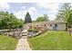 Backyard features a deck, stone steps, and lush landscaping, creating an inviting outdoor living space at 6429 Walnut Way, Brownsburg, IN 46112