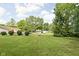 Well-maintained backyard with mature trees, features a storage shed and utility trailer at 6429 Walnut Way, Brownsburg, IN 46112