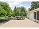 Spacious backyard boasts a patio with a built-in brick grill and lush trees, perfect for entertaining at 6429 Walnut Way, Brownsburg, IN 46112
