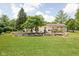 Landscaped backyard featuring a patio, deck, a barbecue area, and a stone-lined garden, perfect for outdoor enjoyment at 6429 Walnut Way, Brownsburg, IN 46112