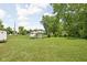 Large, grassy backyard featuring a shed and utility trailer, with potential for various outdoor activities and storage at 6429 Walnut Way, Brownsburg, IN 46112