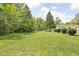 Expansive backyard with lush green grass and mature trees offering a private outdoor space at 6429 Walnut Way, Brownsburg, IN 46112