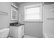 Clean bathroom featuring a vanity with black countertops, a well-lit mirror, and a combined shower-tub at 6429 Walnut Way, Brownsburg, IN 46112