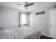 Inviting bedroom featuring neutral tones, soft bedding, a ceiling fan, and wood-look flooring at 6429 Walnut Way, Brownsburg, IN 46112
