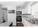 Modern kitchen with stainless appliances, stone countertops, and white cabinets for a classic look at 6429 Walnut Way, Brownsburg, IN 46112