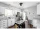 Bright kitchen featuring white cabinetry, stainless steel appliances, and granite countertops with a kitchen island at 6429 Walnut Way, Brownsburg, IN 46112