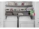 Organized laundry room with washer, dryer, and shelving for ample storage of laundry essentials at 6429 Walnut Way, Brownsburg, IN 46112