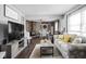 Bright and spacious living room featuring modern decor, a brick fireplace, and an adjoining dining area at 6429 Walnut Way, Brownsburg, IN 46112